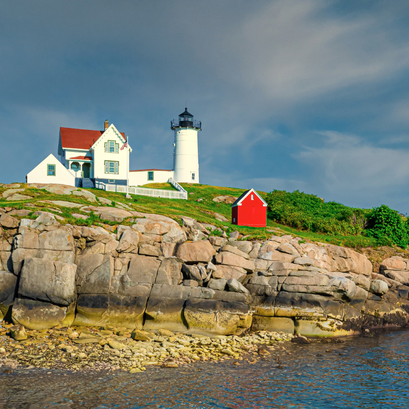 Famous lighthouse in York, Maine. White building with red roof