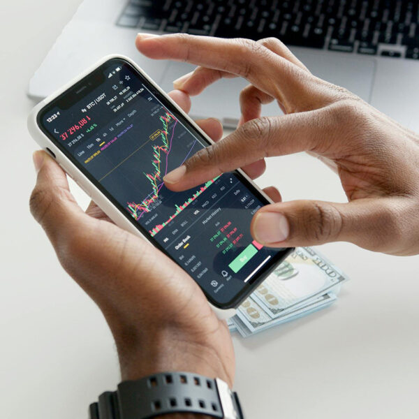 hands holding a smartphone with financial info
